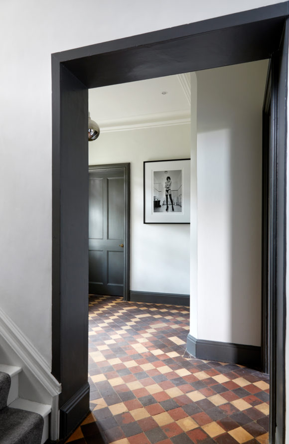 hallway with grey woodwork and tiled floor