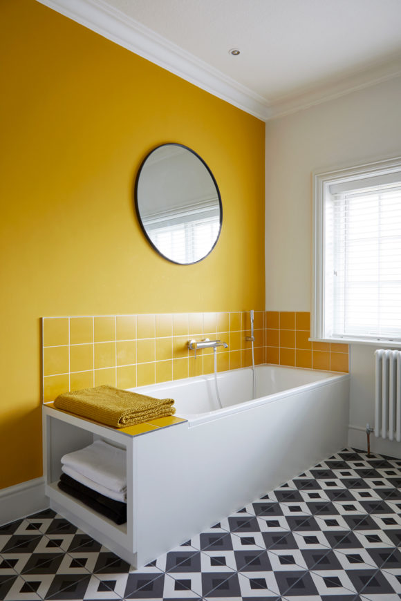 family bathroom with black and white tiles, yellow tiles