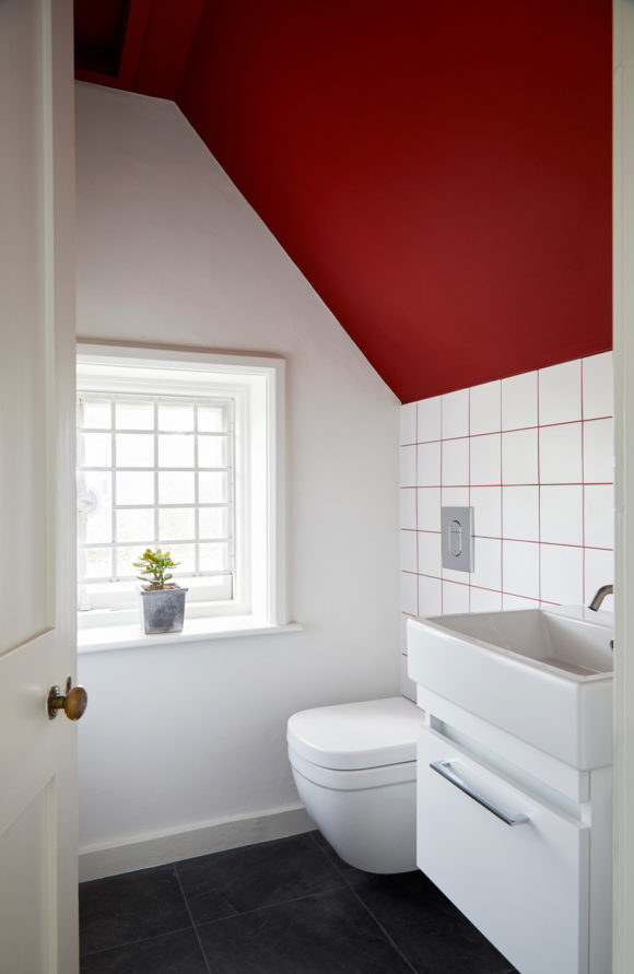 cloakroom with white tiles and red grout, red ceiling
